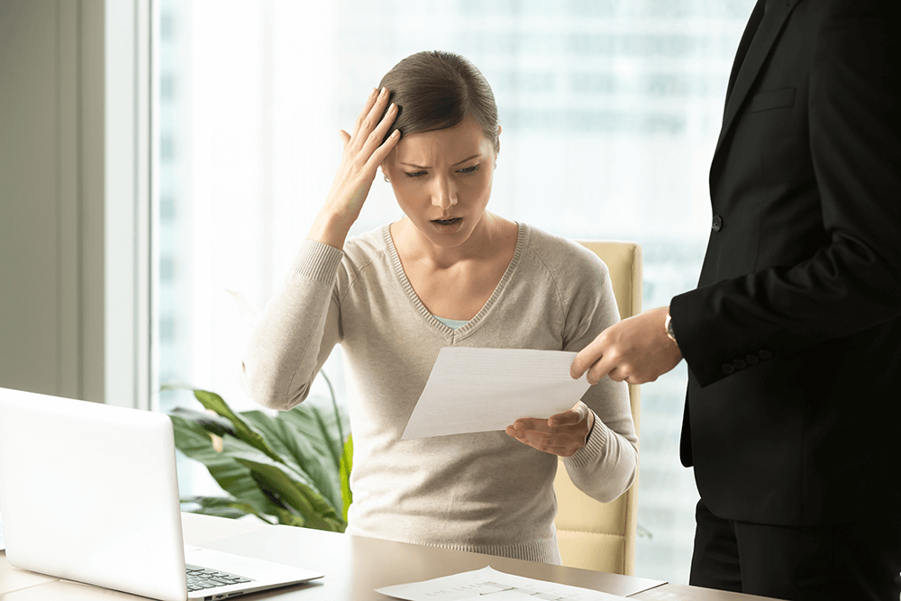 confused woman looking at paper with business claim mistakes on it
